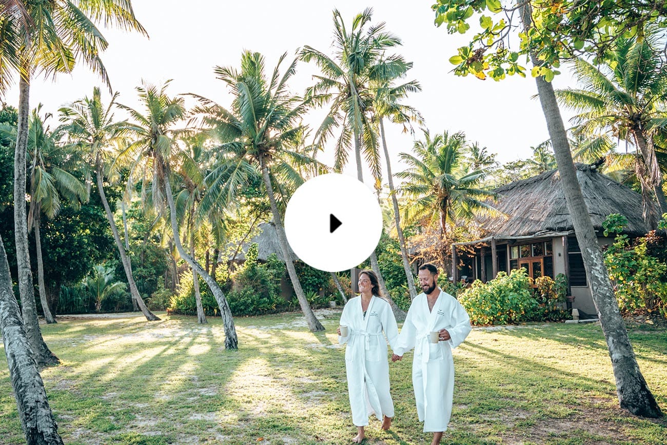 yasawa island resort and spa couple walking outside beach bure
