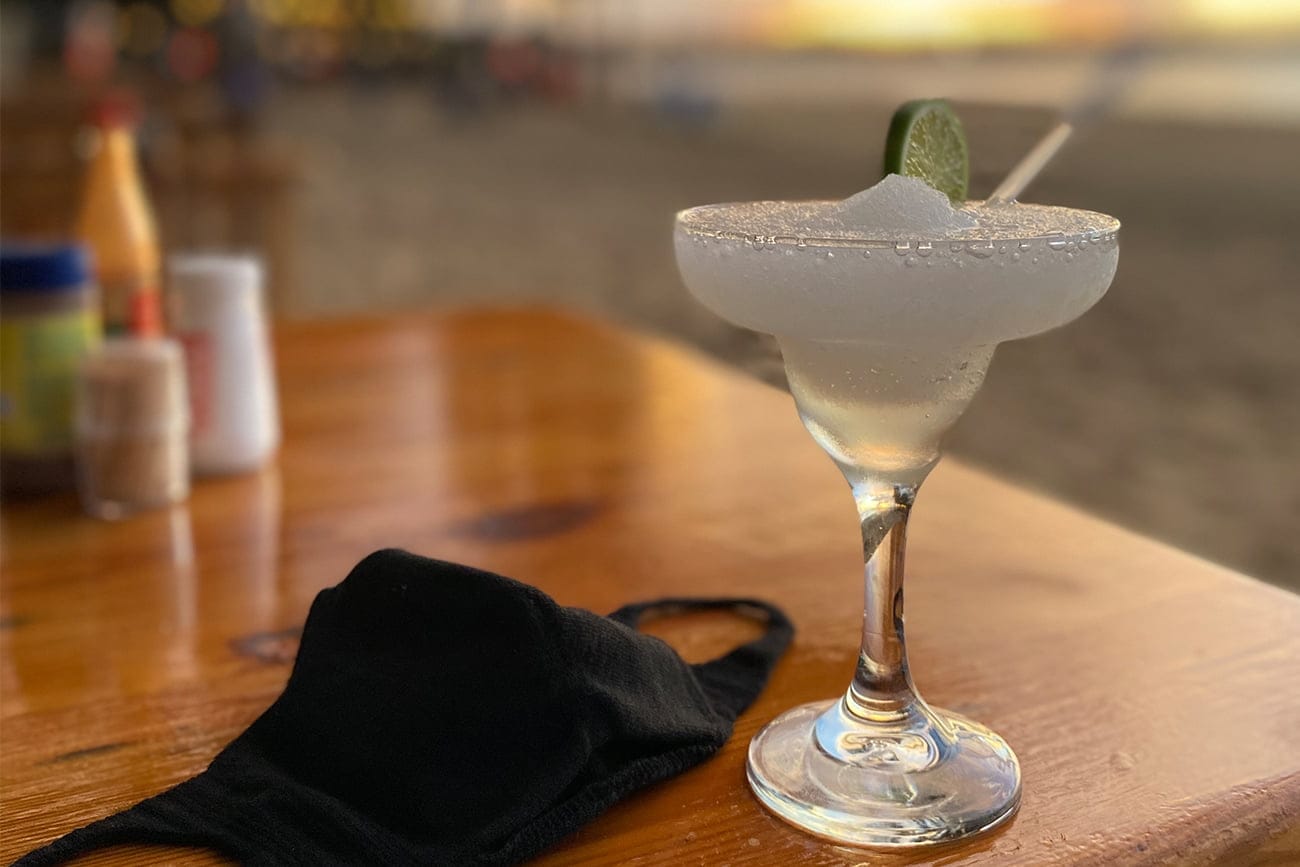 cocktails on the beach with covid mask